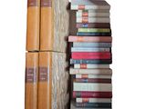 many books stacked on top of each other on a shelf