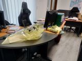 a desk with two computer monitors and a bag on it
