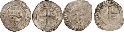 a group of four silver coins with faces on them