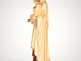 the statue of a woman in a white robe is holding a bird