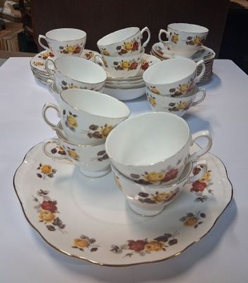 several cups and saucers are sitting on a white table
