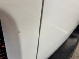 a close up of a car ' s front fender with a ruler on it