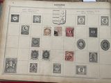 an old book with stamps on it sitting on a table