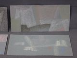 three pieces of paper on a table with a pair of scissors