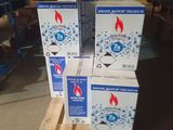 three boxes of water are stacked on pallets in a warehouse