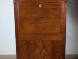 a wooden cabinet with a marble top on a tile floor
