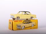 a yellow toy car sitting on top of a yellow box
