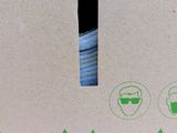 a close up of the inside of a cardboard box with a hole in it