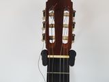 an image of a close up of a guitar on a stand