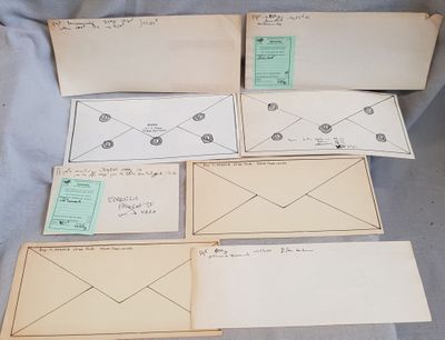 several envelopes are lined up on a blue sheet of paper