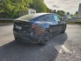 the tesla model x is parked on the side of the road