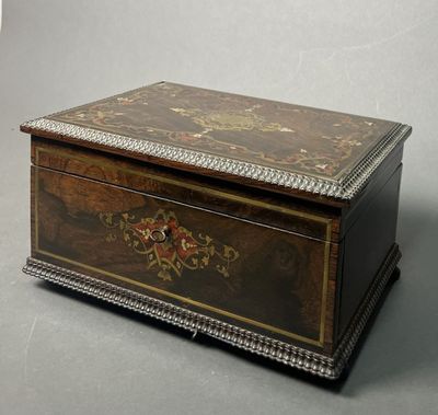 an old wooden box sitting on top of a gray surface