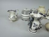 many different types of vases sitting on a table
