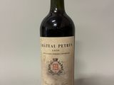 an old bottle of wine sitting on top of a table