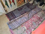 many different rugs on the floor in a room