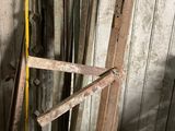 a pile of old wood boards and other tools in a room
