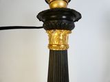a black and gold lamp that is on a table