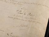 an old document with writing on it sitting on a table