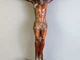statue of jesus on a cross with a bird on it