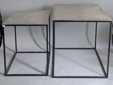 pair of concrete and metal side tables with a black metal frame