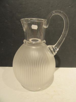 a clear glass pitcher sitting on a white table