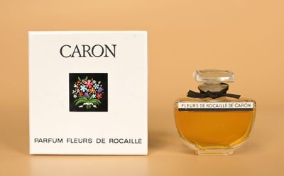 an image of a bottle of perfume sitting next to a box