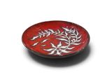 a red plate with a white design on it