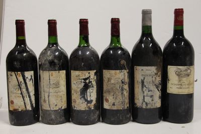six bottles of wine are lined up in a row on a table