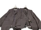 two men ' s suits on a hanger on a white background