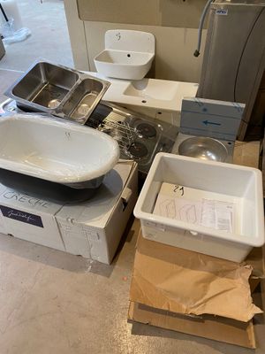 a lot of items that are sitting on the floor in the bathroom