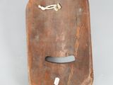 a wooden object with a metal handle on a table