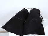 pair of black cloth triangle shaped pillows on top of a white table