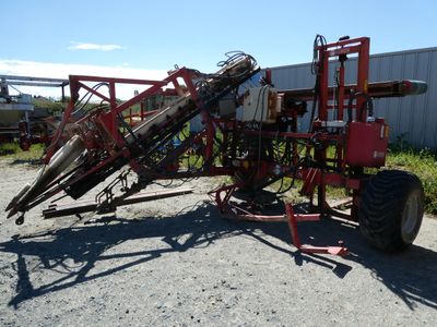 an image of a red tractor with a machine attached to it