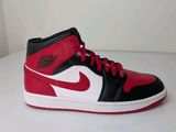a close up of a pair of red and black shoes on a white surface