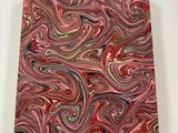 a painting of a red and green swirl on a white surface