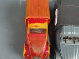 two toy cars sitting next to each other on a table