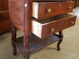 a wooden table with two drawers on it