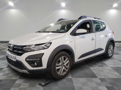 a white car is parked in a room with a checkered floor