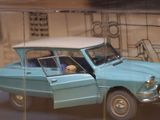 a toy car with a dog sitting in the driver ' s seat