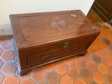 a wooden box sitting on a tiled floor in a room