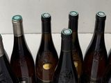 bottles of wine are lined up in a box on a table