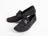 black sued slippers with a metal buckle on the front