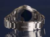 a close up of a watch on a reflective surface