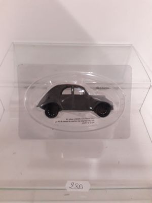 a small black car in a clear display case