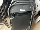 a lot of chairs that are stacked on top of each other