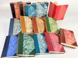 many different colored books stacked on top of each other