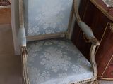 a chair that is next to a dresser in a room