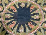 a close up of a rug with a black square in the center