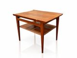 a wooden table with a shelf underneath it