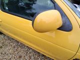 a yellow car that is parked in a lot